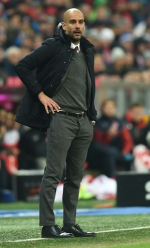Bayern Munich's Spanish headcoach Pep Guardiola follows the German first division Bundesliga football match of FC Bayern Munich v FSV Mainz 05 in Munich, southern Germany on March 2, 2016.
