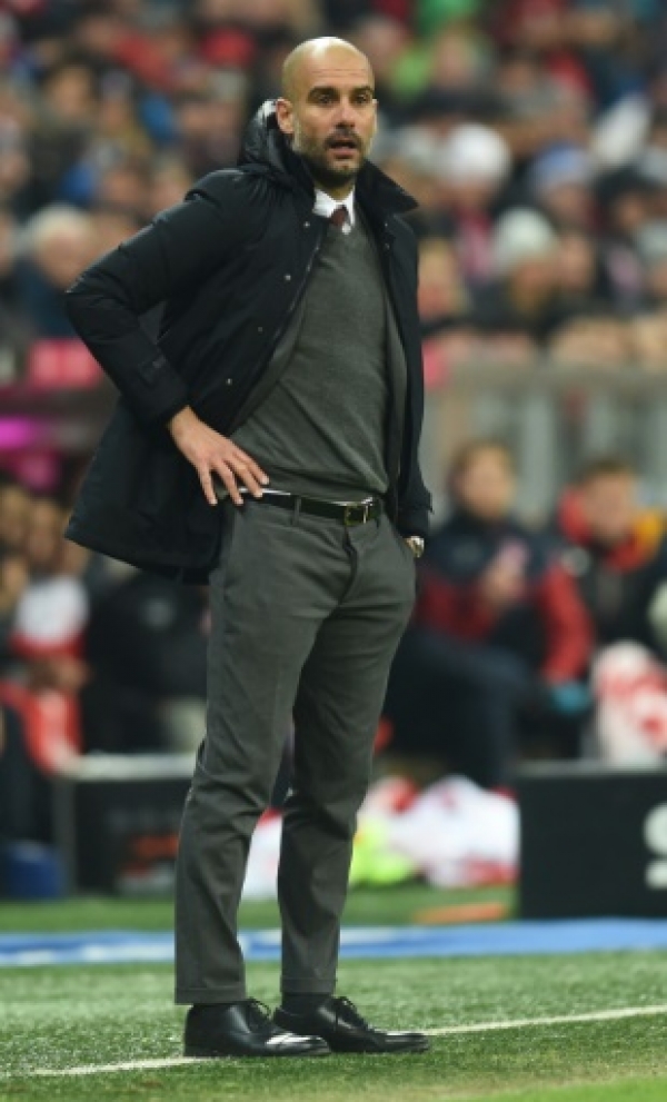 Bayern Munich's Spanish headcoach Pep Guardiola follows the German first division Bundesliga football match of FC Bayern Munich v FSV Mainz 05 in Munich, southern Germany on March 2, 2016.