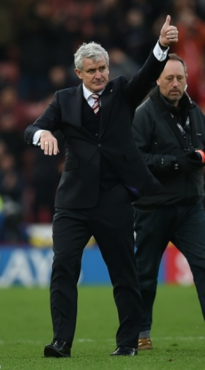 Stoke City's Welsh manager Mark Hughes gestures to the fans following the English Premier League football match between Stoke City and Manchester City at the Britannia Stadium in Stoke-on-Trent, central England on December 5, 2015. Stoke won the match 2-0. AFP PHOTO / PAUL ELLIS RESTRICTED TO EDITORIAL USE. No use with unauthorized audio, video, data, fixture lists, club/league logos or 'live' services. Online in-match use limited to 75 images, no video emulation. No use in betting, games or single club/league/player publications..