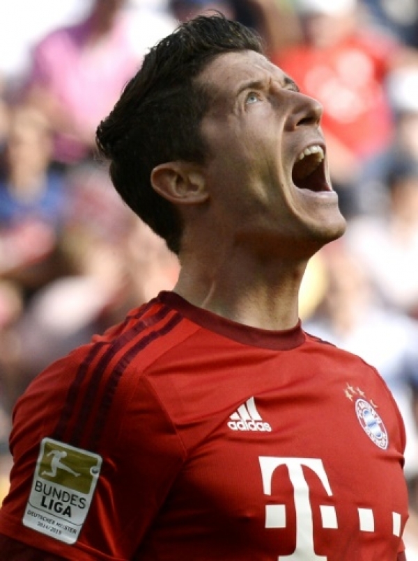 Bayern Munich's Polish forward Robert Lewandowski reacts after scoring a goal during the German first division Bundesliga football match 1899 Hoffenheim v FC Bayern Munich, on August 22, 2015 in Sinsheim. AFP PHOTO / THOMAS KIENZLE RESTRICTIONS: DURING MATCH TIME: DFL RULES TO LIMIT THE ONLINE USAGE TO 15 PICTURES PER MATCH AND FORBID IMAGE SEQUENCES TO SIMULATE VIDEO. == RESTRICTED TO EDITORIAL USE == FOR FURTHER QUERIES PLEASE CONTACT DFL DIRECTLY AT + 49 69 650050.