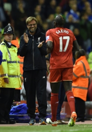 Liverpool's French defender Mamadou Sakho (R) celebrates with Liverpool's German manager Jurgen Klopp after scoring during the English Premier League football match between Liverpool and Everton at Anfield in Liverpool, north west England on April 20, 2016.