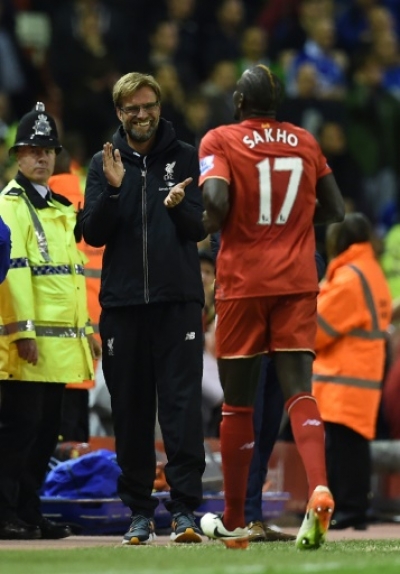 Liverpool's French defender Mamadou Sakho (R) celebrates with Liverpool's German manager Jurgen Klopp after scoring during the English Premier League football match between Liverpool and Everton at Anfield in Liverpool, north west England on April 20, 2016.