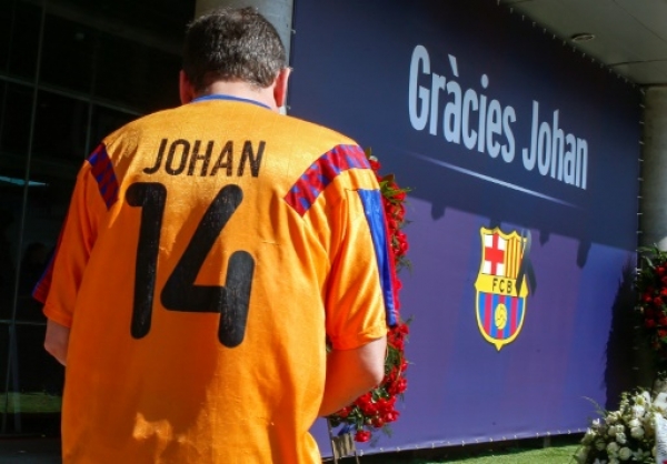 A football fan wearing a jersey of Dutch national team pays tribute to late Dutch football star Johan Cruyff in a special condolence area set up at Camp Nou stadium, in Barcelona on March 26, 2016.Cruyff, one of the greatest footballers of all time who dazzled with his artistry, died on March 24, 2016 at the age of 68 after losing a battle with lung cancer, prompting an avalanche of tributes from around the sports world. Message reads "Thanks Johan."