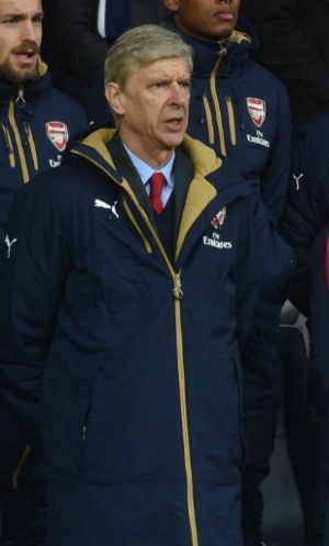 Arsenal's French manager Arsene Wenger sings as 'La Marseillaise' is played for the victims of the Paris terrorist attacks ahead of the English Premier League football match between West Bromwich Albion and Arsenal at The Hawthorns in West Bromwich, central England on November 21, 2015. AFP PHOTO / PAUL ELLIS RESTRICTED TO EDITORIAL USE. No use with unauthorized audio, video, data, fixture lists, club/league logos or 'live' services. Online in-match use limited to 75 images, no video emulation. No use in betting, games or single club/league/player publications.
