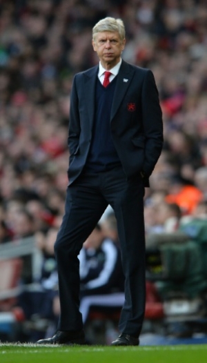 Arsenal's French manager Arsene Wenger watches his players during the English FA Cup fourth round football match between Arsenal and Burnley at the Emirates stadium in London, on January 30, 2016.