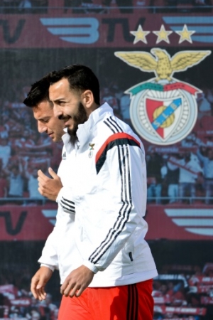 Benfica's Greek forward Kostas Mitroglou (R) walks with Benfica's Greek midfielder Andreas Samaris as they arrive for a training session at Benfica's training field in Seixal, on April 12, 2016, on on the eve of the Champions League quarter final, second-leg football match between SL Benfica and Bayern Munich.