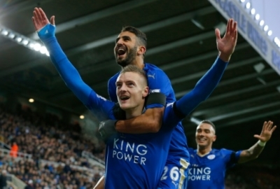 Leicester City's English striker Jamie Vardy (Below L) celebrates after scoring his team's first goal during the English Premier League football match between Newcastle United and Leicester City at St James' Park in Newcastle-upon-Tyne, north east England, on November 21, 2015. AFP PHOTO / LINDSEY PARNABY RESTRICTED TO EDITORIAL USE. No use with unauthorized audio, video, data, fixture lists, club/league logos or 'live' services. Online in-match use limited to 75 images, no video emulation. No use in betting, games or single club/league/player publications.