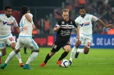 Nice's French forward Valere Germain (2ndR) vis with Marseille's Dutch defender Karim Rekik (2ndL) and Marseille's French-Togolese midfielder Jacques-Alaixys Romao (R) during the French L1 football match Olympique de Marseille vs Nice on November 8, 2015 at the Velodrome stadium in Marseille, southern France. AFP PHOTO / BERTRAND LANGLOIS