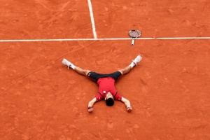 Djokovic deitado no meio do cora&ccedil;&atilde;o que desenhou na quadra de Roland Garros, em 5 de junho, em Paris