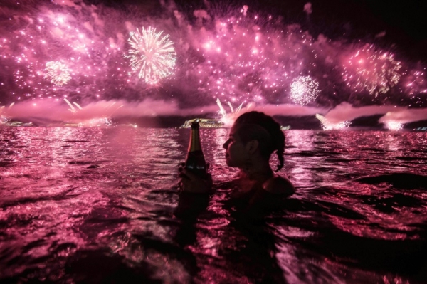 Mulher observa fogos de artif&iacute;cio na praia de Copacabana em 1 de janeiro de 2016