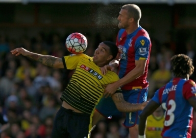 (FILES) Watford striker Troy Deeney (L) vies with Crystal Palace defender Brede Hangeland during an English Premier League football match at Vicarage Road in Watford, north of London on September 27, 2015. Ex-prisoner Deeney has invited six fellow inmates to watch him achieve the peak of his rehabilitation November 21, 2015 in a glamour Premier League clash against Manchester United. AFP PHOTO / IAN KINGTON