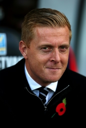 Swansea City's English manager Garry Monk awaits kickoff ahead of the English Premier League football match between Swansea City and Arsenal at The Liberty Stadium in Swansea, south Wales on October 31, 2015. Arsenal won the game 3-0. AFP PHOTO / GEOFF CADDICK RESTRICTED TO EDITORIAL USE. No use with unauthorized audio, video, data, fixture lists, club/league logos or 'live' services. Online in-match use limited to 75 images, no video emulation. No use in betting, games or single club/league/player publications.