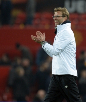 Liverpool's German manager Jurgen Klopp applauds supporters after the UEFA Europa League round of 16, second leg football match between Manchester United and Liverpool at Old Trafford in Manchester, north west England on March 17, 2016.The game ended 1-1, Liverpool going through 3-1 on aggregate.