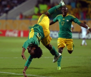 South African forward Kermit Erasmus (18) executes a double flip as teammate South African forward George Maluleka (17) runs towards him in celebration of scoring the opening goal of the match against Ghana, during the second half of the game played between Ghana and South Africa in the FIFA World Cup second round football match played in the city of Ismailia, 140 kilometers north east of Cairo on October 6, 2009. AFP PHOTO/CRIS BOURONCLE