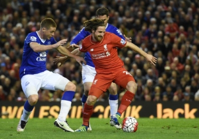 Liverpool's Welsh midfielder Joe Allen (R) shrugs off a tackle during the English Premier League football match between Liverpool and Everton at Anfield in Liverpool, north west England on April 20, 2016.