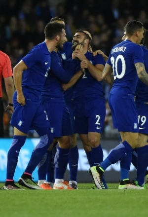 Ioannis Maniatis (C) of Greece is congratulated by team-mates after getting the ball past Adam Federici of Australia to score against the Australian Socceroos during their international friendly match in Melbourne on June 7, 2016.