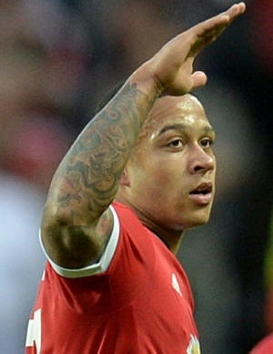 Manchester United's Dutch midfielder Memphis Depay (L) celebrates after scoring his team's second goal during the UEFA Champions League play off football match between Manchester United and Club Brugge at Old Trafford in Manchester, north west England, on August 18, 2015. AFP PHOTO / OLI SCARFF