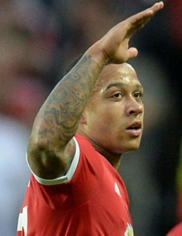 Manchester United's Dutch midfielder Memphis Depay (L) celebrates after scoring his team's second goal during the UEFA Champions League play off football match between Manchester United and Club Brugge at Old Trafford in Manchester, north west England, on August 18, 2015. AFP PHOTO / OLI SCARFF