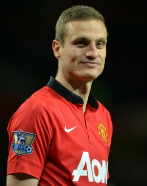 Manchester United's Serbian defender Nemanja Vidic smiles after speaking to the crowd after the English Premier League football match between Manchester United and Hull City at Old Trafford in Manchester, northwest England on May 6, 2014. The Premier League fixture against Hull was the final time club captain Vidic, 32, turned out in front of the Old Trafford faithful as a United player, with the Serbia centre-back joining Inter Milan after the end of the season. Manchester United won the game 3-1. AFP PHOTO / PAUL ELLIS RESTRICTED TO EDITORIAL USE. No use with unauthorized audio, video, data, fixture lists, club/league logos or &ldquo;live&rdquo; services. Online in-match use limited to 45 images, no video emulation. No use in betting, games or single club/league/player publications.