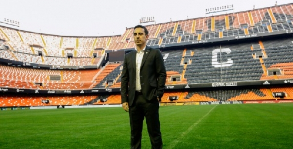 England football coach Gary Neville stands during his official presentation as Valencia's new coach on December 3, 2015. Neville's appointment as Valencia boss for the remainder of the season was received with shock in Spain on Wednesday as Singaporean businessman and club owner Peter Lim attempts to protect his multi-million euro investment in the struggling La Liga side. AFP PHOTO / JOSE JORDAN