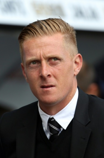 (FILES) In a file picture taken on August 23, 2014 Swansea City's English manager Garry Monk arrives for the English Premier League football match between Swansea City and Burnley at the Liberty Stadium in Swansea. Swansea City manager Garry Monk has been sacked, the club announced on December 9, 2015. AFP PHOTO / GEOFF CADDICK RESTRICTED TO EDITORIAL USE. No use with unauthorized audio, video, data, fixture lists, club/league logos or &ldquo;live&rdquo; services. Online in-match use limited to 45 images, no video emulation. No use in betting, games or single club/league/player publications.