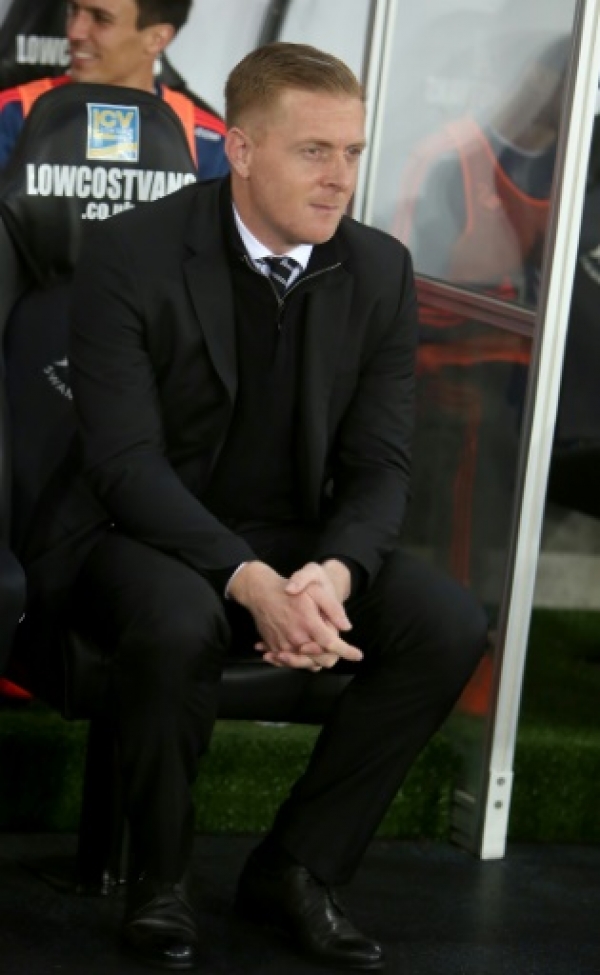Swansea City&rsquo;s English manager Garry Monk sits in the dugout during the English Premier League football match between Swansea City and Leicester City at The Liberty Stadium in Swansea, south Wales on December 5, 2015. Swansea City&rsquo;s English manager Garry Monk sits in the dugout during the English Premier League football match between Swansea City and Leicester City at The Liberty Stadium in Swansea, south Wales on December 5, 2015. AFP PHOTO / GEOFF CADDICK RESTRICTED TO EDITORIAL USE. No use with unauthorized audio, video, data, fixture lists, club/league logos or 'live' services. Online in-match use limited to 75 images, no video emulation. No use in betting, games or single club/league/player publications.