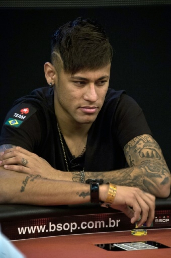 Brazilian football star and Barcelona player Neymar gestures during the Charity Home Game poker tournament in Sao Paulo, Brazil, on July 26, 2015. AFP PHOTO / Nelson ALMEIDA