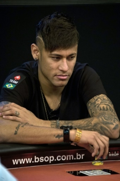Brazilian football star and Barcelona player Neymar gestures during the Charity Home Game poker tournament in Sao Paulo, Brazil, on July 26, 2015. AFP PHOTO / Nelson ALMEIDA