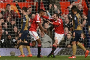 Manchester United's English striker Marcus Rashford (2L) celebrates scoring their first goal with Manchester United's Spanish midfielder Juan Mata (2R) during the English Premier League football match between Manchester United and Arsenal at Old Trafford in Manchester in north west England on February 28, 2016.
