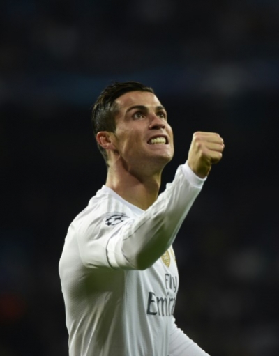 Real Madrid's Portuguese forward Cristiano Ronaldo celebrates after scoring during the UEFA Champions League Group A football match Real Madrid CF vs Malmo FF at the Santiago Bernabeu stadium in Madrid on December 8, 2015. AFP PHOTO/ PIERRE-PHILIPPE MARCOU