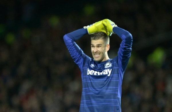 West Ham United's Spanish goalkeeper Adrian reacts after a missed chance during the English Premier League football match between Manchester United and West Ham United at Old Trafford in Manchester, north west England, on December 5, 2015. AFP PHOTO / OLI SCARFF RESTRICTED TO EDITORIAL USE. No use with unauthorized audio, video, data, fixture lists, club/league logos or 'live' services. Online in-match use limited to 75 images, no video emulation. No use in betting, games or single club/league/player publications.