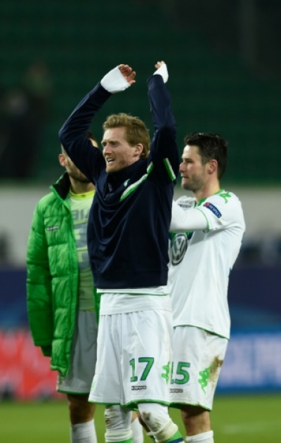 Wolfsburg's striker Andre Schuerrle (c) and teammates react after 1-0 victory during the second-leg round of 16 UEFA Champions league football match between VfL Wolfsburg and KAA Gent at the Volkswagen arena in Wolfsburg on March 8, 2016.