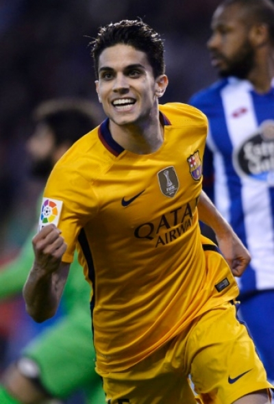 Barcelona's defender Marc Bartra celebrates after scoring a goal during the Spanish league football match RC Deportivo de la Coruna vs FC Barcelona at the Municipal de Riazor stadium in La Coruna on April 20, 2016. Barcelona won the match 8-0.