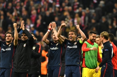Atletico Madrid players celebrate qualifying for the final after the UEFA Champions League semi-final, second-leg football match between FC Bayern Munich and Atletico Madrid in Munich, southern Germany, on May 3, 2016.