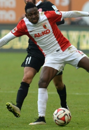 Augsburg's defender Abdul Rahman Baba (R) of Ghana and Mainz's midfielder Yunus Malli (L) vie for the ball during the German first division Bundesliga football match FC Augsburg v Mainz 05 in Augsburg, southern Germany, on March 14, 2015. AFP PHOTO / CHRISTOF STACHE DFL RULES TO LIMIT THE ONLINE USAGE DURING MATCH TIME TO 15 PICTURES PER MATCH. IMAGE SEQUENCES TO SIMULATE VIDEO IS NOT ALLOWED AT ANY TIME. FOR FURTHER QUERIES PLEASE CONTACT DFL DIRECTLY AT + 49 69 650050.