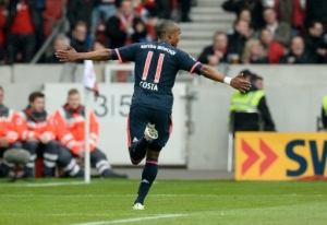 Bayern Munich's Brazilian forward Douglas Costa celebrates during the German first division Bundesliga football match between VfB Stuttgart and Bayern Munich in Stuttgart, southwestern Germany, on April 9, 2016. Bayern Munich won 3-1.