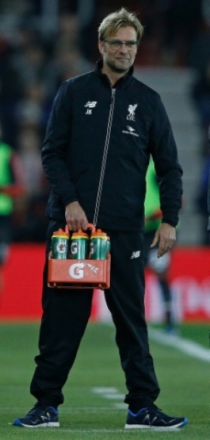 Liverpool's German manager Jurgen Klopp holds the drinks bottles as he stands on the touchline during the English League Cup quarter-final football match between Southampton and Liverpool at St Mary's Stadium in Southampton, southern England on December 2, 2015. AFP PHOTO / ADRIAN DENNIS RESTRICTED TO EDITORIAL USE. No use with unauthorized audio, video, data, fixture lists, club/league logos or 'live' services. Online in-match use limited to 75 images, no video emulation. No use in betting, games or single club/league/player publications.